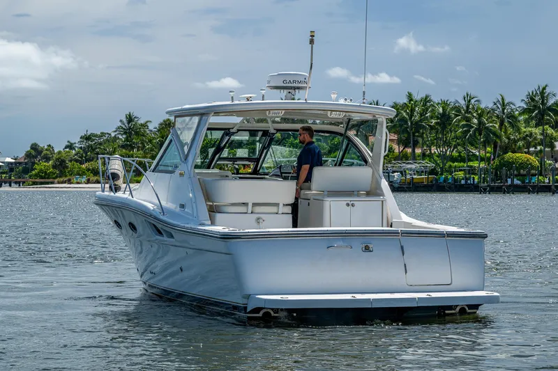 Slide: The Image of 2008 Tiara Yachts 3200 Open cruising on a scenic waterway with palm trees. - 9