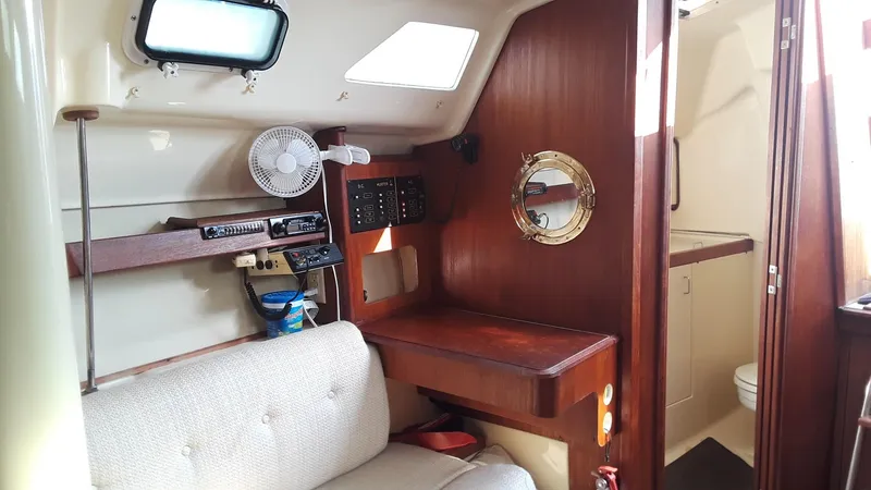 Slide: The Image of Interior of 1990 Hunter 28 sailboat with wooden paneling and cozy seating area. - 10
