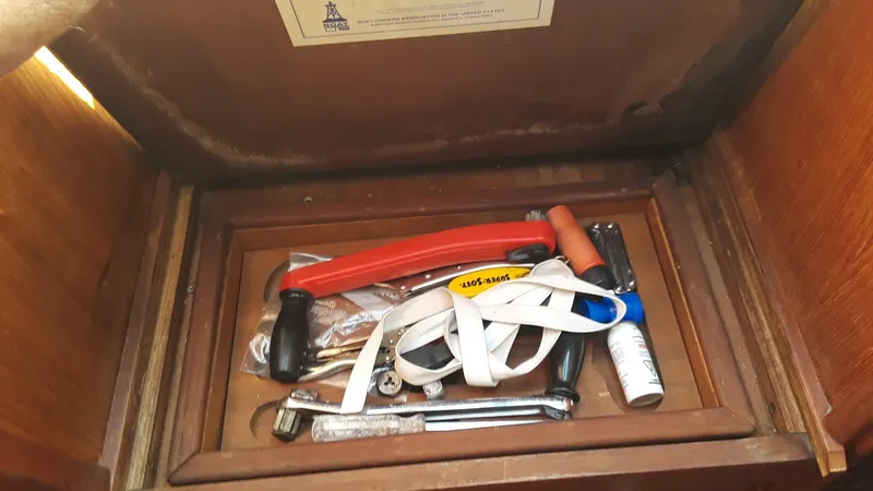 Slide: The Image of Toolbox inside a 1990 Hunter 28 sailboat, containing various tools and accessories. - 22