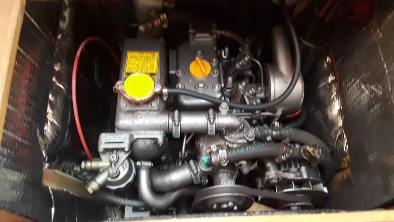 Slide: The Image of Engine of a 1990 Hunter 28 sailboat, showing mechanical components and wiring. - 24