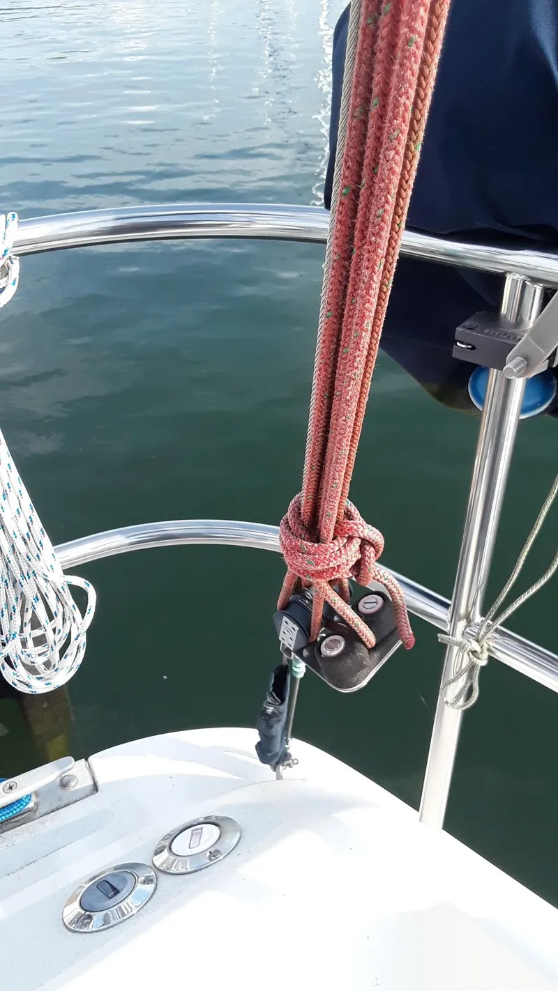 Slide: The Image of Sailboat deck with ropes and fittings, Hunter 28, 1990 model, on calm water. - 25