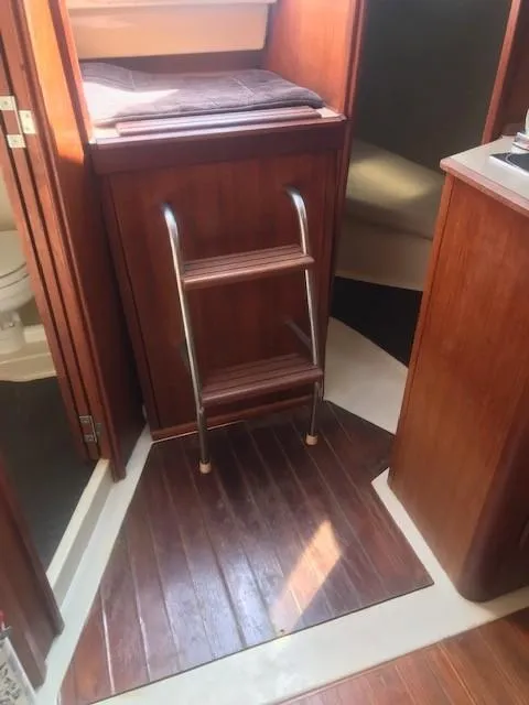 Slide: The Image of Interior of 1990 Hunter 28 sailboat with wooden ladder and cabin view. - 29