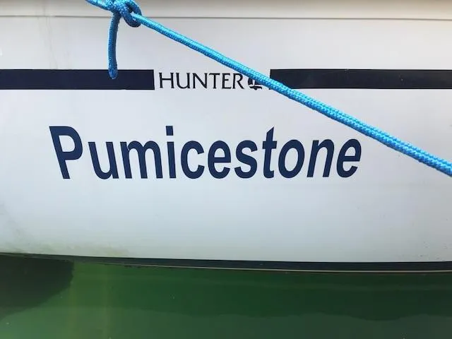 Slide: The Image of Hunter 28 sailboat named "Pumicestone" with blue rope, 1990 model. - 31