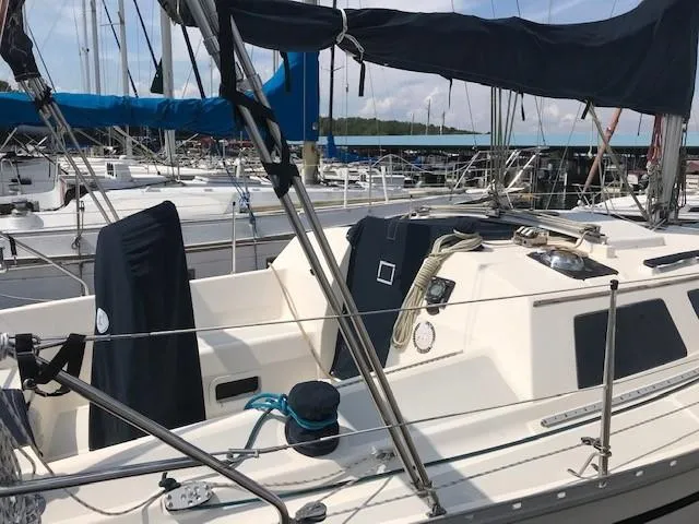 Slide: The Image of Hunter 28 sailboat from 1990 docked at a marina, featuring a clean deck and rigging. - 34