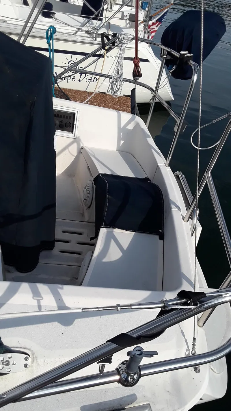 Slide: The Image of 1990 Hunter 28 sailboat cockpit with seating and nautical equipment. - 36