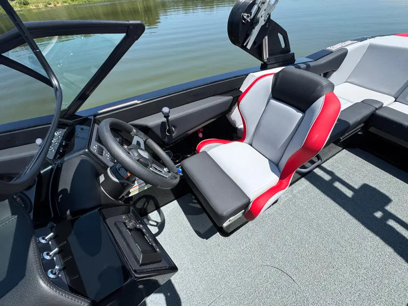 Slide: The Image of 2022 MasterCraft NXT22 boat interior with steering wheel and red-accented seat. - 13