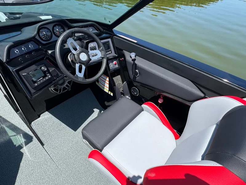Slide: The Image of 2022 MasterCraft NXT22 boat interior with steering wheel and dashboard controls. - 14