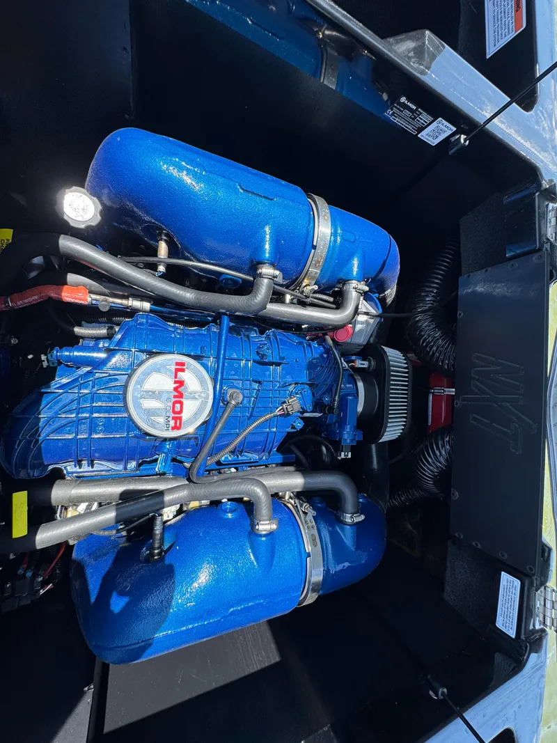 Slide: The Image of 2022 MasterCraft NXT22 engine compartment with blue Ilmor engine components. - 28