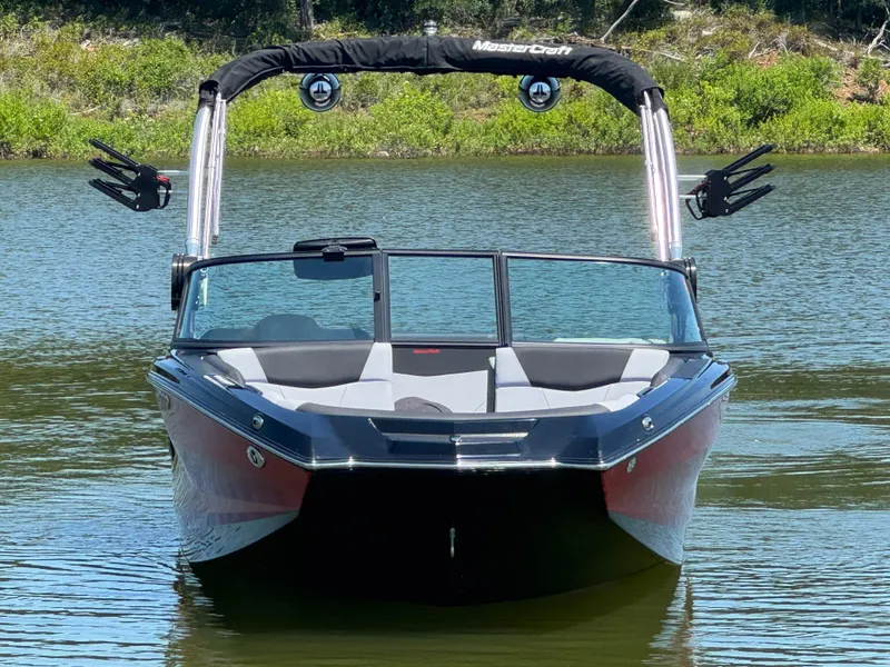 Slide: The Image of 2022 MasterCraft NXT22 boat on calm water, featuring sleek design and modern wakeboard tower. - 3