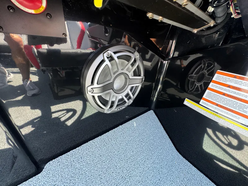 Slide: The Image of 2022 MasterCraft NXT22 boat interior with speaker and warning labels. - 31