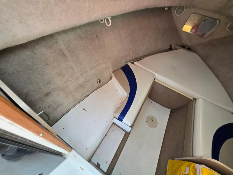 Slide: The Image of Interior cabin of 1996 Wellcraft Excel 23 Walk Around boat, featuring seating and storage. - 10