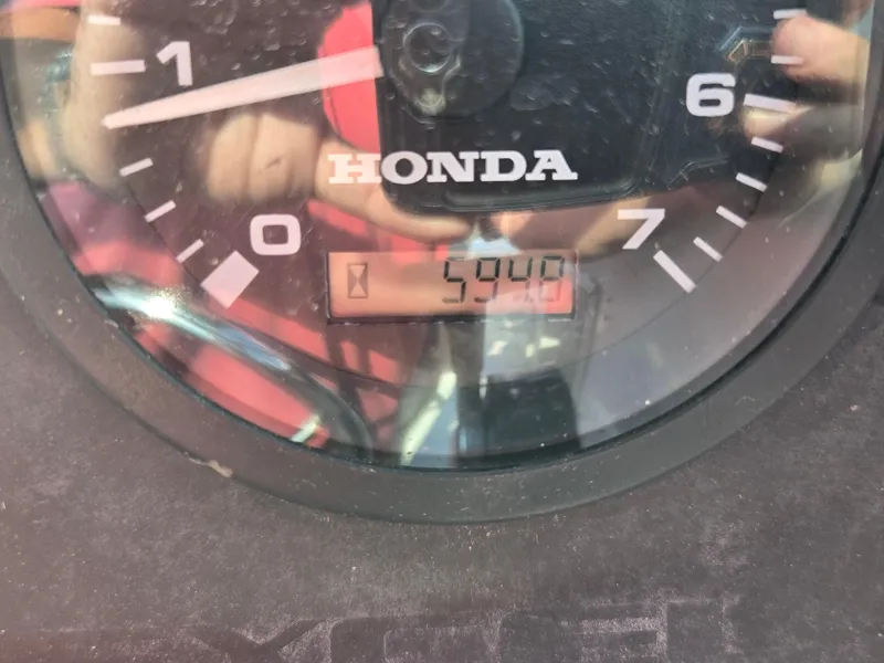 Slide: The Image of Close-up of a Honda tachometer displaying 5940 RPM on a Wellcraft Excel 23 Walk Around boat. - 14