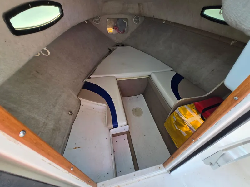 Slide: The Image of 1996 Wellcraft Excel 23 Walk Around cabin interior with seating and storage. - 3