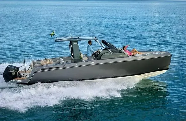The Image of 2025 Schaefer V33 boat cruising on open water with passengers enjoying the ride. - 0