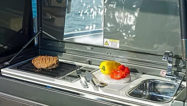 Slide: The Image of Outdoor kitchen on Schaefer V33 yacht with grill, vegetables, and sink, 2025 model. - 32