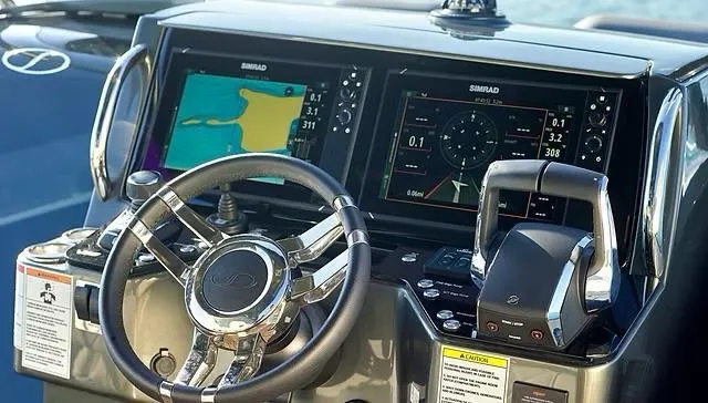 Slide: The Image of Steering console of 2025 Schaefer V33 boat with navigation screens and controls. - 9