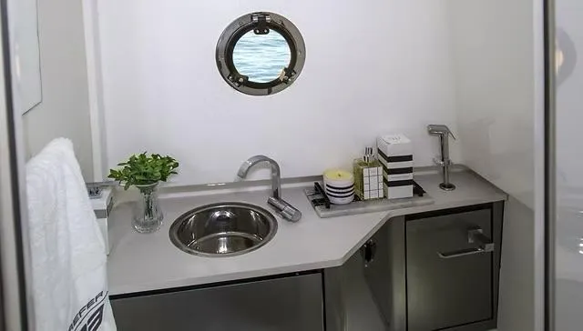 Slide: The Image of Modern bathroom in 2025 Schaefer V33 yacht with sink, porthole, and sleek cabinetry. - 26