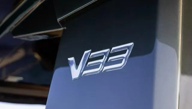 Slide: The Image of Close-up of 2025 Schaefer V33 model emblem on a sleek surface. - 6