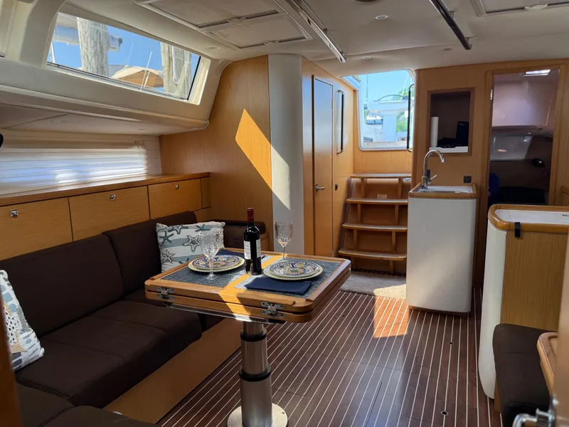 Slide: The Image of Interior of 2012 Bavaria Vision 46 yacht with elegant dining setup and modern wood finish. - 10
