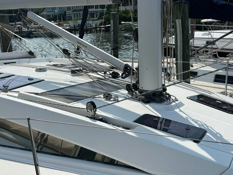 Slide: The Image of Sailboat deck of 2012 Bavaria Vision 46, featuring rigging and hatches at a marina. - 5