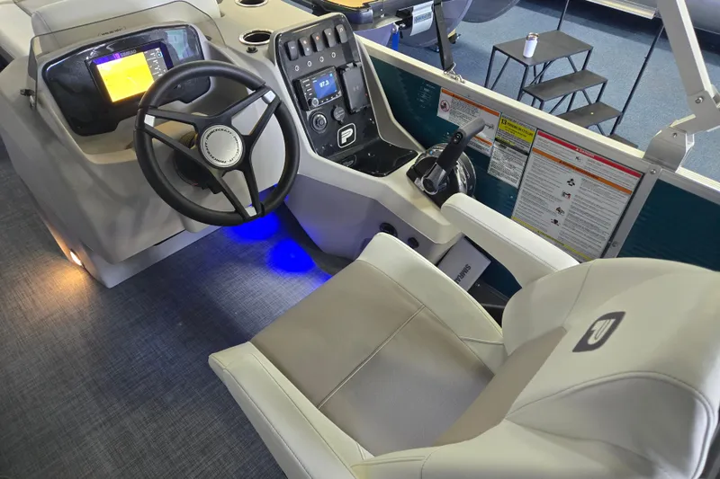 Slide: The Image of 2025 Princecraft Vectra 23 RL boat cockpit with steering wheel, controls, and comfortable seating. - 12