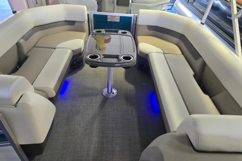 Slide: The Image of Interior of 2025 Princecraft Vectra 23 RL pontoon boat with plush seating and table. - 13