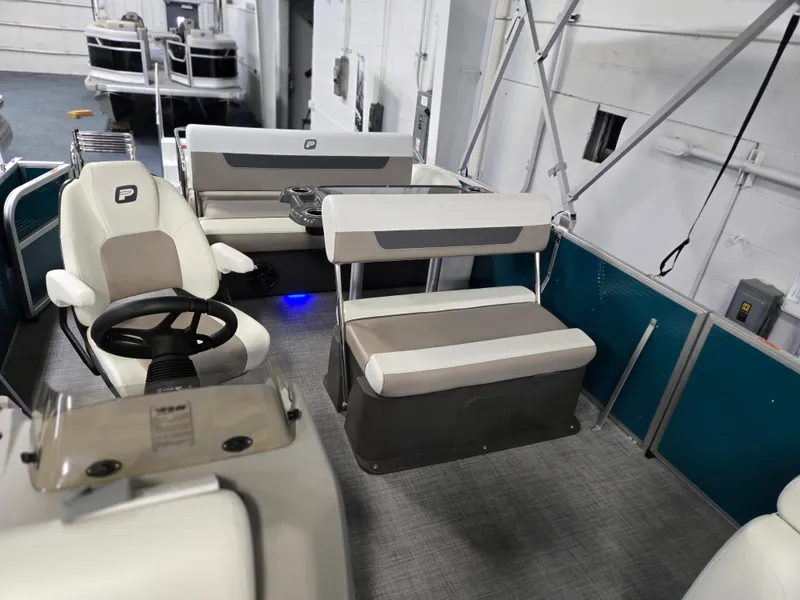 Slide: The Image of 2025 Princecraft Vectra 23 RL pontoon boat interior with seating and steering wheel. - 6
