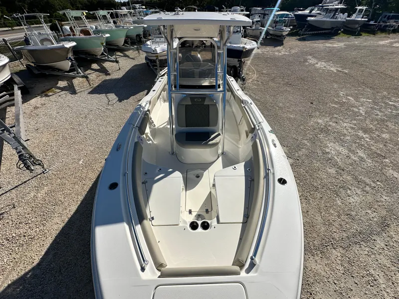 Slide: The Image of 2025 Key West 239 FS boat, white exterior, parked in a marina with other boats. - 18