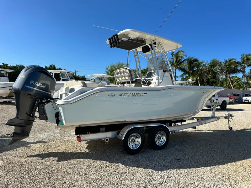 Slide: The Image of 2025 Key West 239 FS boat on trailer with Yamaha engine, parked outdoors. - 5