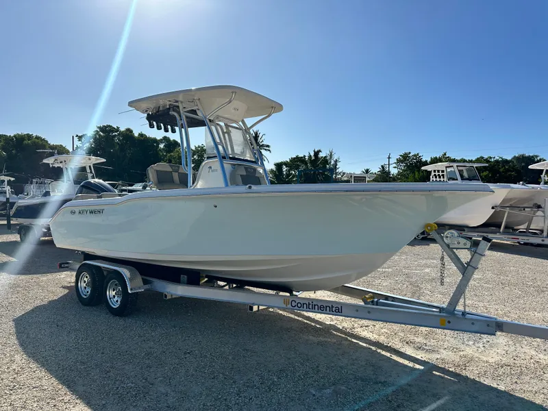 Slide: The Image of 2025 Key West 239 FS boat on trailer under clear blue sky. - 6
