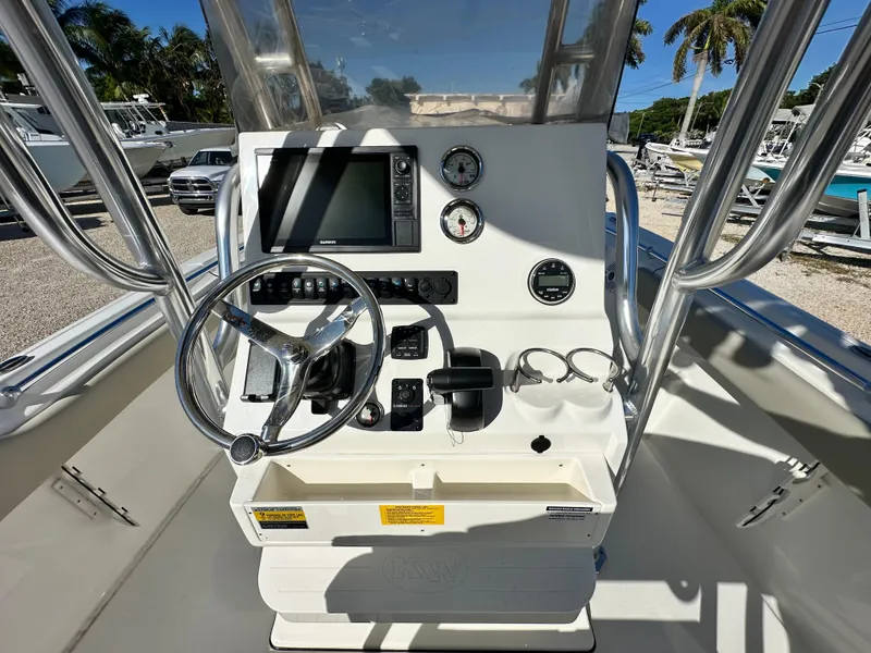 Slide: The Image of 2025 Key West 239 FS boat console with steering wheel, gauges, and navigation system. - 9