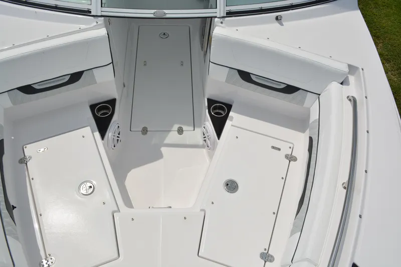 Slide: The Image of 2026 Blackfin 252 DC boat interior with white seating and storage compartments. - 10