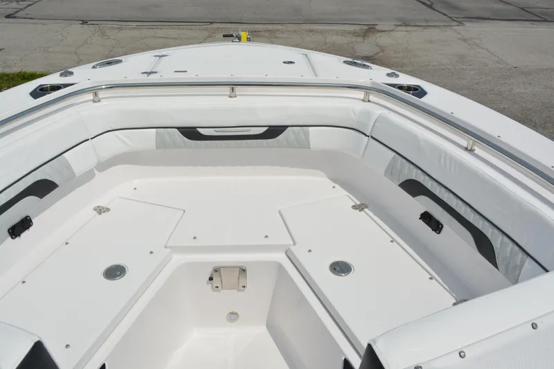 Slide: The Image of 2026 Blackfin 252 DC boat interior with white seating and storage compartments. - 11