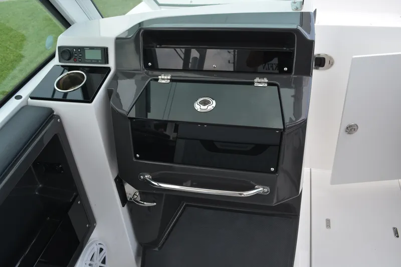 Slide: The Image of Interior of 2026 Blackfin 252 DC boat, featuring sleek control panel and storage compartments. - 15