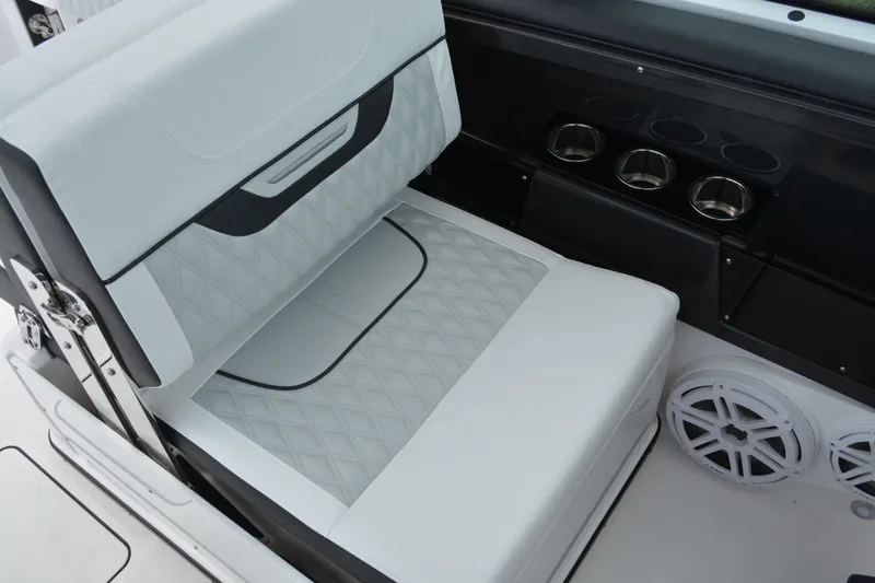 Slide: The Image of 2026 Blackfin 252 DC boat interior with white cushioned seating and cup holders. - 21