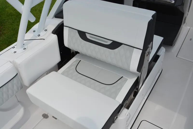 Slide: The Image of 2026 Blackfin 252 DC boat seat with white and gray upholstery, featuring diamond stitching. - 23