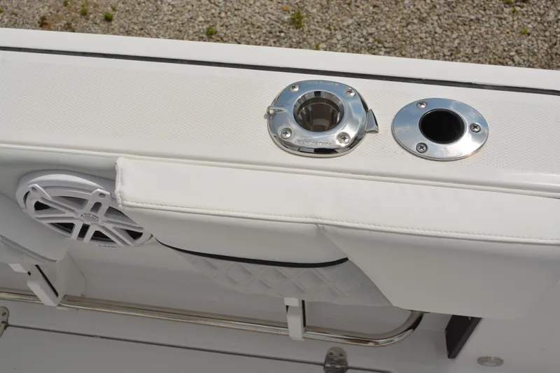Slide: The Image of 2026 Blackfin 252 DC boat detail with rod holders and speaker on white deck. - 29