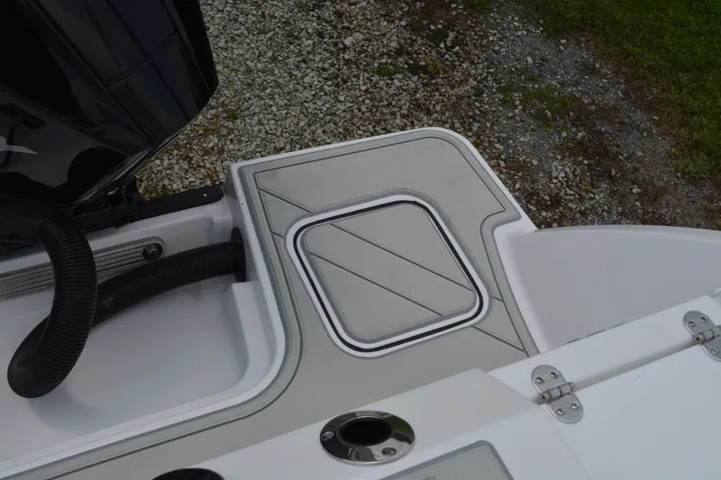 Slide: The Image of 2026 Blackfin 252 DC boat deck with storage compartment and engine detail. - 35