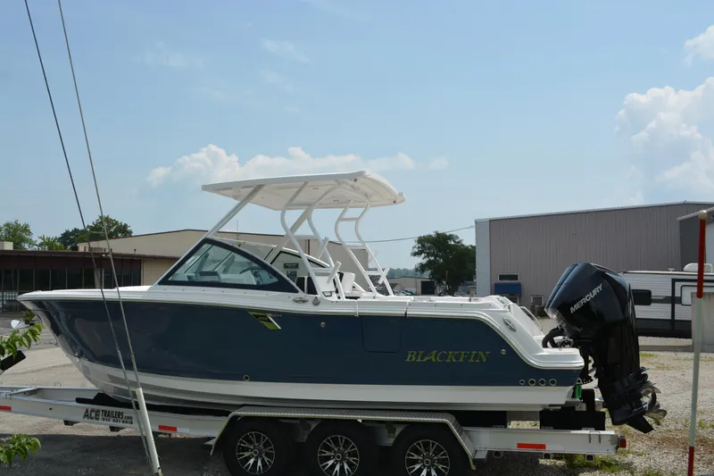 Slide: The Image of 2026 Blackfin 252 DC boat on trailer, parked outdoors under clear sky. - 5