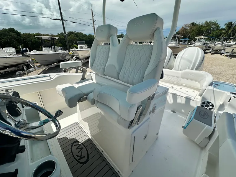 Slide: The Image of 2025 Key West 263 FS boat interior with luxurious seating and steering wheel. - 10