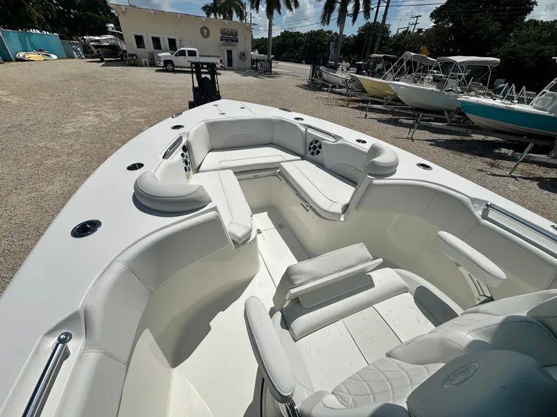Slide: The Image of 2025 Key West 263 FS boat interior with white seating and spacious layout. - 11