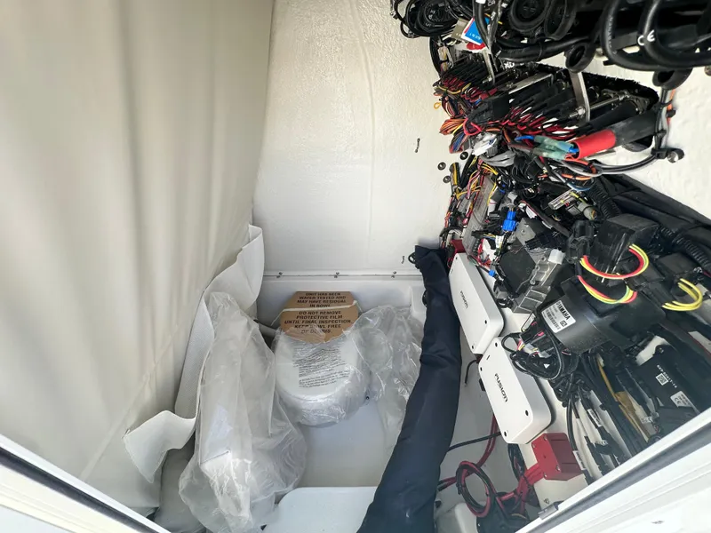 Slide: The Image of Interior view of 2025 Key West 263 FS boat's wiring and storage compartment. - 12