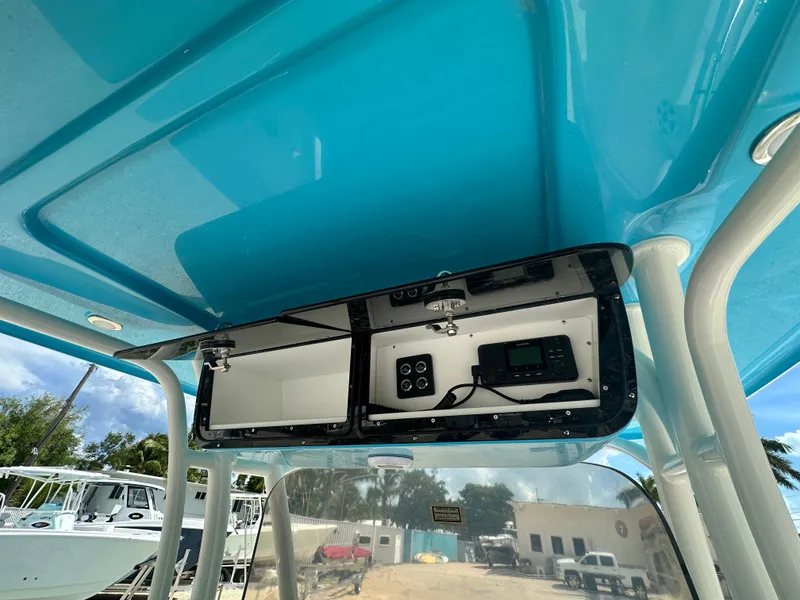 Slide: The Image of 2025 Key West 263 FS boat console with open storage and electronic controls. - 16