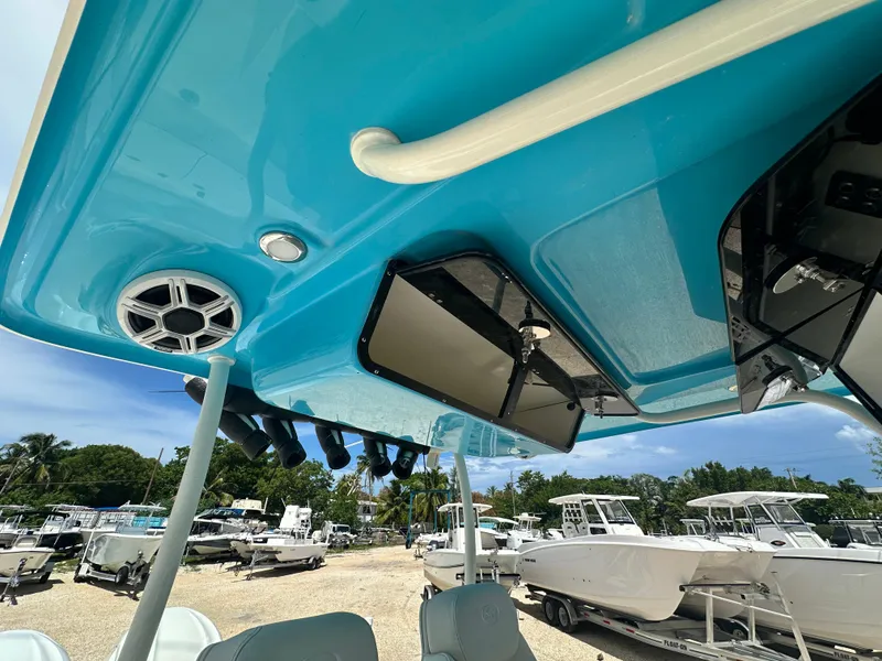 Slide: The Image of 2025 Key West 263 FS boat interior with blue ceiling and speaker system. - 17
