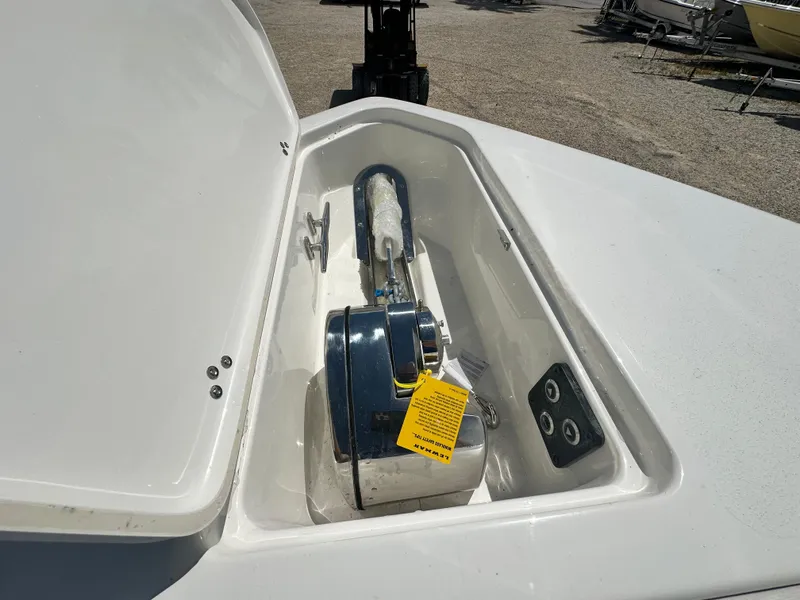 Slide: The Image of Open anchor compartment on 2025 Key West 263 FS boat, showing anchor and winch. - 18