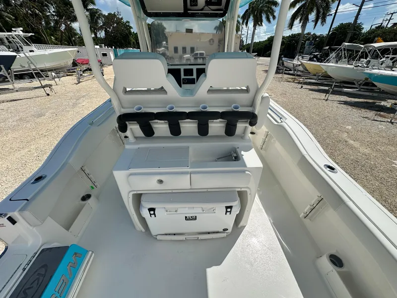 Slide: The Image of 2025 Key West 263 FS boat interior with seating, storage, and cup holders. - 8