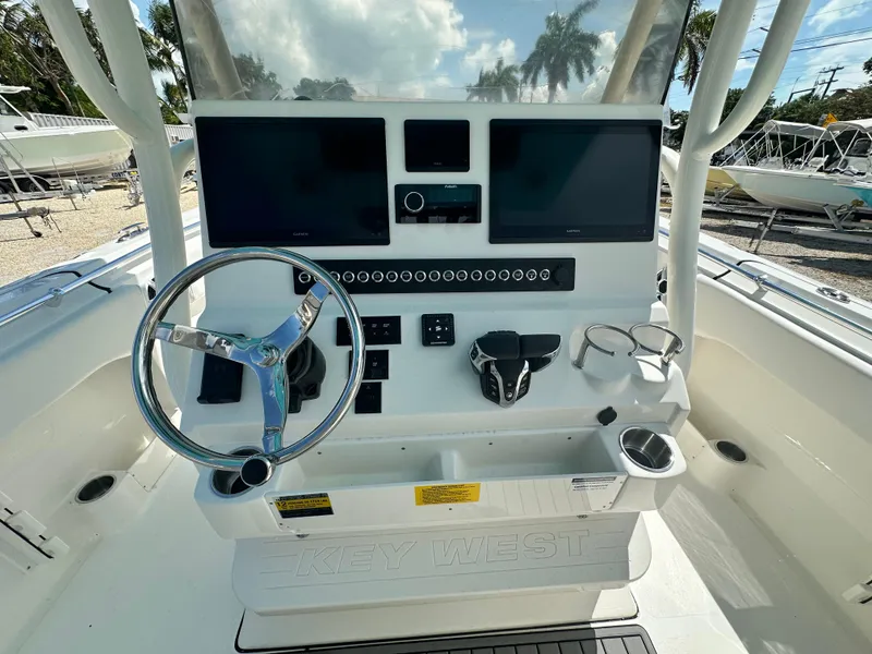 Slide: The Image of 2025 Key West 263 FS boat dashboard with dual screens and steering wheel. - 9