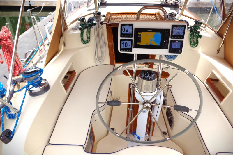 Slide: The Image of Cockpit of 2005 Pacific Seacraft 40 sailboat with navigation instruments and steering wheel. - 8