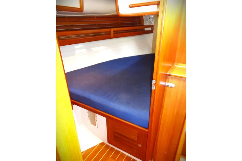 Slide: The Image of Cozy cabin interior of 2005 Pacific Seacraft 40 sailboat with blue bedding. - 6