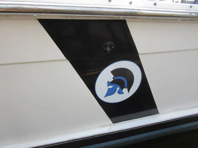 Slide: The Image of 1977 Trojan F30 Express boat with Spartan helmet logo on the side. - 13